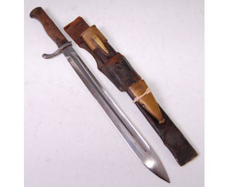 A German model 98/05 mauser bayonet the 36cm single edged fullered blade stamped to the ricasso C.G. Haenel Suhl, in a brass 