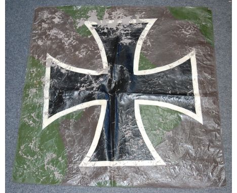 A patch of canvas with printed German Iron Cross emblem, possibly cut from a German plane, 78 x 78cm.