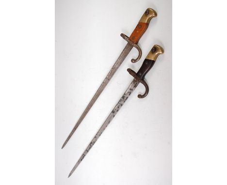 A French model 1874 Gras bayonet, the 52cm fullered Yataghan shaped blade inscribed to the back edge Mre d'armes de St Etienn