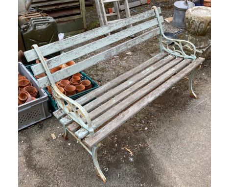 A slatted garden bench with cast iron ends 