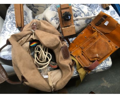 A suede tool belt, together with a small Cotton Traders holdall containing ropes, bungees and straps 