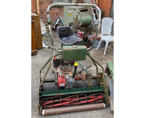 An Atco petrol lawnmower with Briggs &amp; Stratton engine and seat with roller 