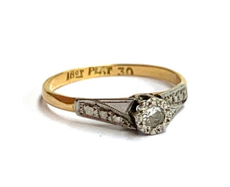 An early 20th century 18ct gold and platinum illusion set diamond ring, size M, 6 1/4, 1.6g 