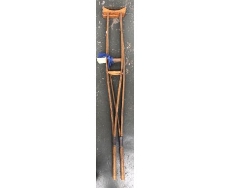 An extraordinarily large pair of vintage crutches, made for a 6'8" man, 159cm long 