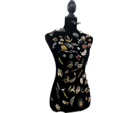 Large selection of assorted Vintage and later brooches on a mannequin body