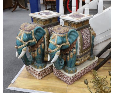 A pair of Chinese Guandong pottery ‘elephant and howdah’ stands, 56cm high