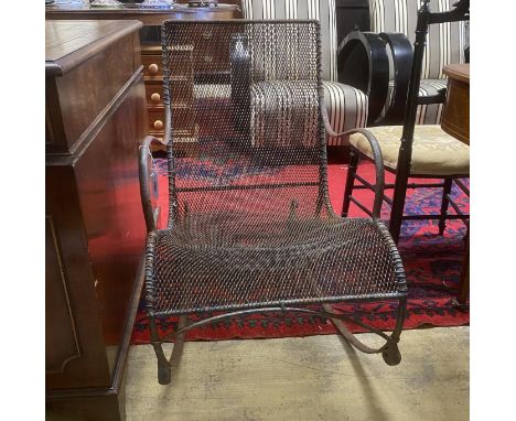 A vintage wrought iron and mesh garden rocking chair, width 53cm, depth 85cm, height 78cm