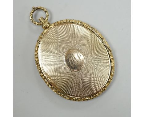 A Victorian engine turned yellow metal (tests as 9ct gold) oval pendant locket, housing a miniature on ivory depicting a lady