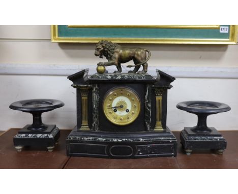 An early 20th century black slate clock garniture with metal lion mount, clock 37cm high
