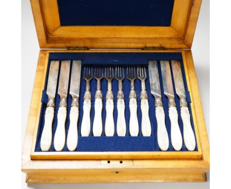 A Victorian cased set of twelve pairs of silver dessert knives and forks, with crested carved mother of pearl handles, Sheffi
