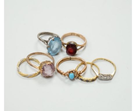 Seven assorted dress rings, comprising an 18ct gold three stone diamond ring, size M, a 9ct gold dress ring with associated w