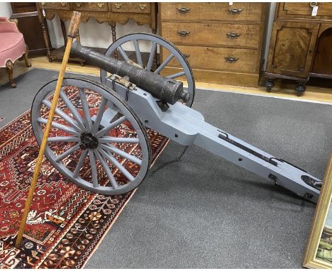 A model artillery cannon with composition barrel on painted spoke frame, length 193cm, height 84cm