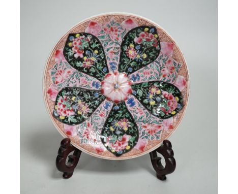A Chinese famille rose cup stand, early Qianlong period, decorated in relief with a flowerhead, 15cm in diameter Provenance -