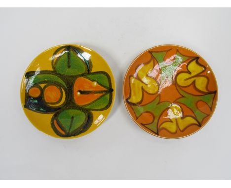 Two Poole Delphis orange and yellow ground plates with green, yellow and black detail. 20cm diameter