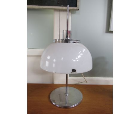 A Harvey Guzzini table lamp with white plastic dome shade on chrome base. Labelled.