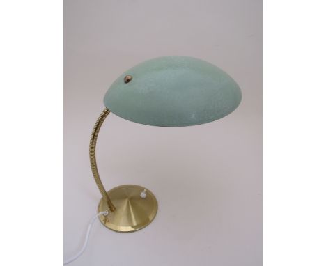 An adjustable green painted metal desk lamp with brass stem and base 