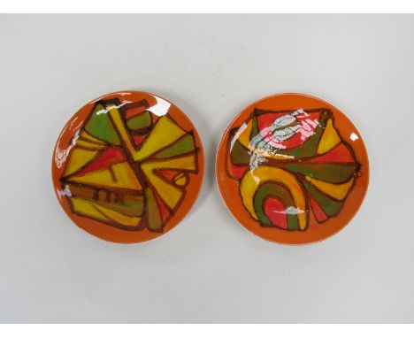 Two Poole Delphis orange ground plates with green and yellow detail. 20cm diameter.