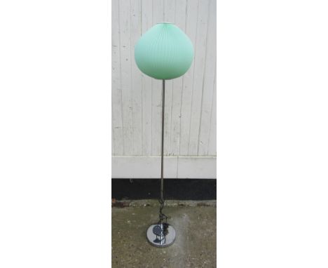 A chromed metal standard lamp with a pleated green plastic shade 