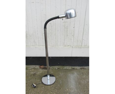 An chrome floor lamp with adjustable single spot light 