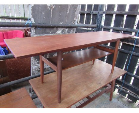 A teak coffee table with under-shelf raised on tapering round legs 