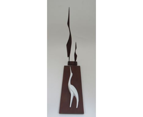 A pair of carved wooden herons on a wooden base and a ceramic and wood wall plaque 