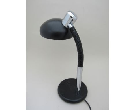 A flexible black and chromed metal desk lamp 