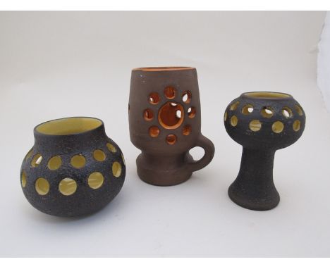 Three Swedish ceramic candle holders with holed bodies and yellow and orange glazed interiors by Norrmans & Gabriel 