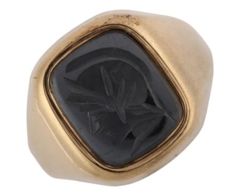 A 9ct gold hematite centurion seal signet ring, intaglio carved with head profile, setting height 15.6mm, size O, 5.1gNo dama