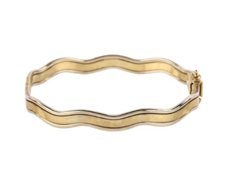 A 9ct two-tone gold hinged bangle, wave design, band width 7.7mm, internal circumference 18cm, 13.2gNo damage or repairs, onl