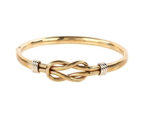 A 9ct gold knot hinged bangle, setting height 12.3mm, internal circumference 17cm, 11.8gNo damage or repairs, a few extremely