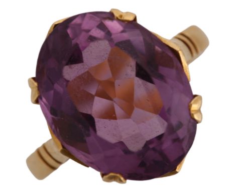 A late 20th century amethyst dress ring, unmarked gold settings with oval mixed-cut amethyst, setting height 14.5mm, size M, 