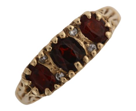 A 9ct gold seven stone garnet and diamond half hoop ring, hallmarks Birmingham 1997, setting height 5.9mm, size M, 3gNo damag