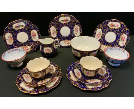 A late 19th century Staffordshire part tea service, comprising two cups, saucer and five side plates, decorated with four pan