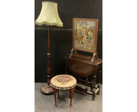 A 20th century drop leaf occasional table, 72cm high, 73cm wide, c.1930;  a standard lamp;  a stool, tapestry stuffed over to