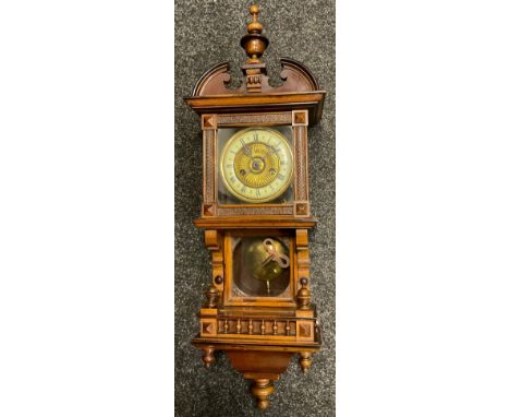 A German walnut wall clock, Roman numerals, twin winding holes, the case with spire finial, glazed pendulum case above a gall