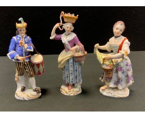 A Meissen figure, of a musician, he stands wearing a feathered hat, playing a flute and holding a drum, 14.5cm high, crossed 