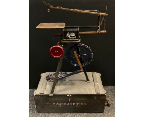 A Hobbies Triumph treadle operated Fretsaw, cast iron tripod base, 94cm high, 70c, long;  an ammunition box tool box, 40lbs s