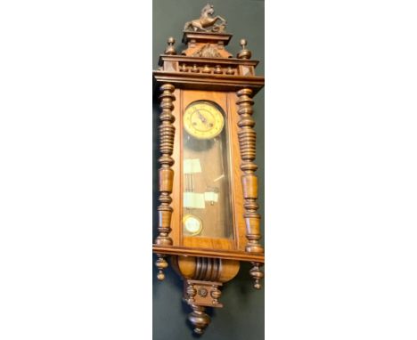 A late 19th century Vienna wall clock, cream dial, Arabic numerals, rearing Horse cresting, 125cm high 