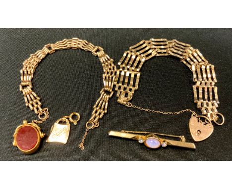 A 9ct gold gate bracelet, pad lock clasp;  another smaller, 20.4g;  a 18ct gold mounted oval seal fob, bloodstone and carneli
