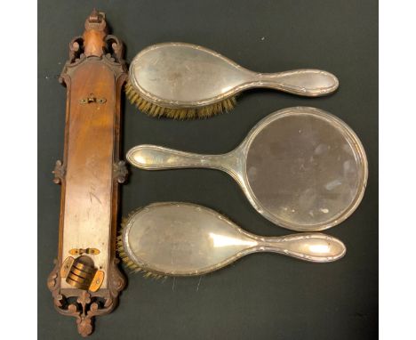 A silver backed hand mirror, Deakin &amp; Francis, Birmingham 1937;  pair of silver backed brushes, marks worn;  carved therm