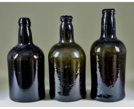 A Wine Bottle of Cylindrical Form of Olive Green Tint, Late 18th Century, with moulded string rim, 9.5ins high, another of ol