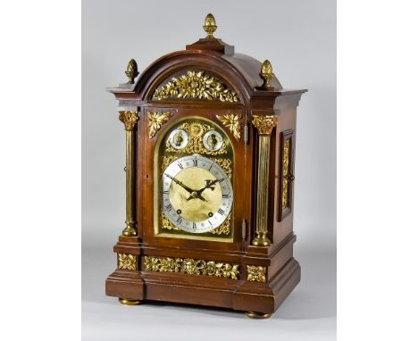 A Late 19th/Early 20th Century Mahogany Cased Mantel Clock by Winterhalder &amp; Hofmeier, the arched brass dial with silvere