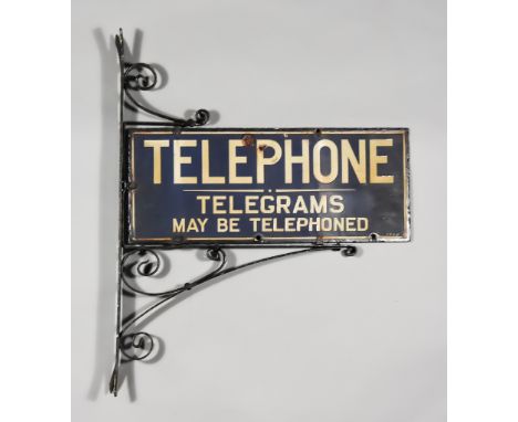 A "Telephone, Telegrams May Be Telephoned" Double-Sided Enamel Sign, Early 20th Century, 9ins x 22ins, mounted onto wrought i