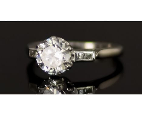 A Platinum Solitaire Diamond Ring, Modern, set with a brilliant cut white diamond, approximately 1.30ct, flanked by four smal