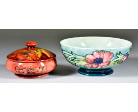 A Moorcroft Pottery Flambé Circular Bowl and Cover, of compressed form, with leaf and berry pattern on a red ground, impresse