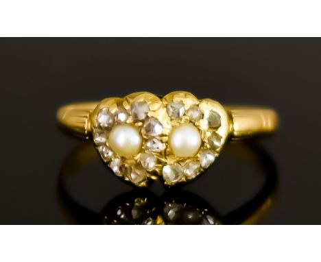 A Small Yellow Metal Lovers Ring in the Regency Manner, in the form of two intertwined hearts, each set with a centre seed pe