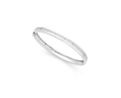 A diamond bangle Of hinged design, the front collet-set with a row of round brilliant-cut diamonds, stamped 18ctDimensions:In