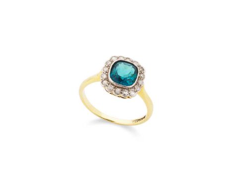 A blue tourmaline and diamond cluster ring Collet-set with a cushion-cut blue tourmaline, in a border of eight-cut diamonds, 