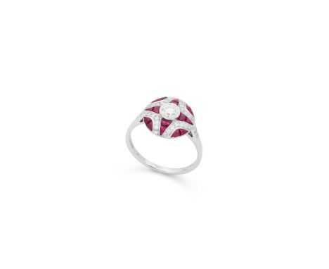 A ruby and diamond cluster ring Millegrain-set with a round brilliant-cut diamond, in a border of  calibré-cut rubies and sma