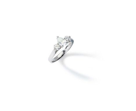 A diamond three-stone ring Claw-set with a pear-shaped diamond, weighing approximately 0.75cts, and two round brilliant-cut d